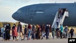 Afghans disembark from a U.S. Air Force aircraft after an evacuation flight from Kabul in Rota in southern Spain on August 31, 2021.