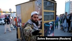 A Taliban fighter reacts to a photographer at a market in Kabul on October 15.
