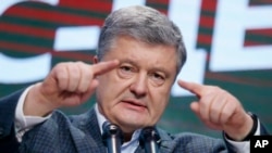 Ukrainian President Petro Poroshenko gestures while speaking at his headquarters in Kyiv after the presidential voting on March 31.