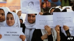 Afghan students in Herat pray for the early recovery of Pakistani child activist Malala Yousafzai, who was shot in the head in a Taliban assassination attempt, on October 13.