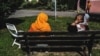 Two Afghan women sit on a bench after their evacuation from Kabul, in Villeurbanne, near Lyon, in 2021. 