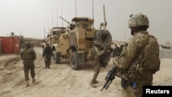 U.S. soldiers keep watch at the entrance of the U.S. base in Panjwai district of Kandahar Province.