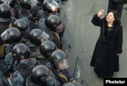 An opposition supporter stands alone in front of a wall of riot police in central Yerevan on March 1, 2008. Eight demonstrators and two police officers died in postelection violence in the capital.