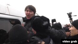 One of the antidevaluation protesters is detained by police in Almaty on February 15.