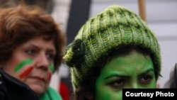 A woman wears the trademark green of the current Iranian opposition during a recent demonstration to express support in France. (photo by Maryam)