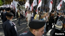 Supporters of Yulia Tymoshenko march on the street near the high court building in Kyiv on August 21.