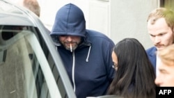 Defendant Yury Harauski enters a court building in Switzerland on the first day of hearings on September 19.