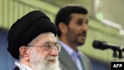 In a photo released by his official website, Supreme Leader Ayatollah Ali Khamenei listens to a speech by President Mahmud Ahmadinejad during an official ceremony in Tehran.