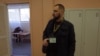 Yuriy Petrenko, a member of the National Militia, monitors voting at School No.14 in Podil, in Kyiv, on March 31.