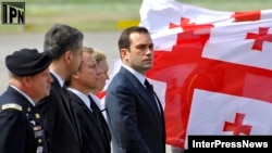 Georgian Defense Minister Irakli Alasania (center) attends the return of coffins of Georgian soldiers killed in Afghanistan at the airport in Tbilisi last month.