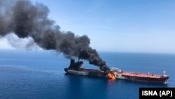 An oil tanker on fire in the Sea of Oman on June 13