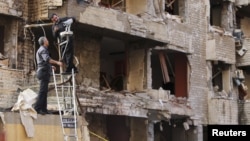 Lebanese security personnel adjust surveillance cameras at the entrance of the Iranian Embassy in Beirut on November 19, following twin bombings that killed 23 people.