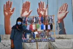 A street vendor sells facemasks amid a coronavirus pandemic in Kabul.