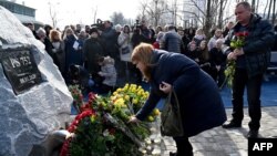 Mourners attend the unveiling of a memorial for those who died in the crash of Ukraine International Airlines Flight 752 at the Boryspil International airport outside Kyiv on February 17.