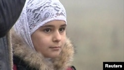 A young girl wear Islamic-style head scarf in Stavropol, in sourthern Russia.