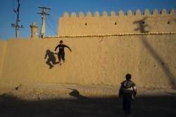 Boys play in the ancient center of Bukhara in March.