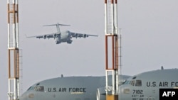 A U.S. cargo plane lands on the runway of the Manas air base.