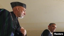 "The New York Times" report suggested a video conference that "ended badly" between Afghan President Hamid Karzai (left) and U.S. President Barack Obama highlighted "slowly unraveling" relations between the two leaders.