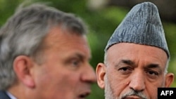 President Karzai (right, with NATO Secretary-General Jaap de Hoop Scheffer) faces intense public pressure over civilian killings