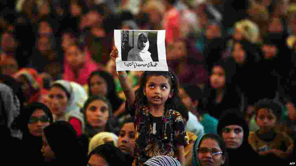 &nbsp;A girl holds a photograph of Malala during a rally in Karachi.