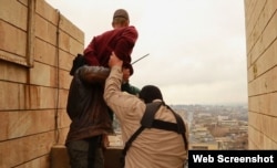 Islamic State militants prepare to throw a man from a rooftop in Mosul in January as punishment for being gay.