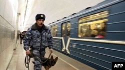 A police officer with a bomb-sniffing dog patrols the Lubyanka subway station in Moscow.