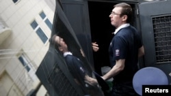 Former Ukrainian Interior Minister Yuriy Lutsenko gets into a police truck after a court session in Kyiv in August 2012.