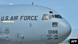 U.S. soldiers board a plane to Afghanistan from the Manas air base.