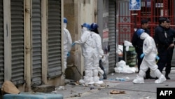 Forensics of the French police are at work outside a building in the northern Paris suburb of Saint-Denis, November 19, 2015