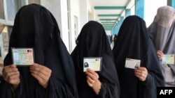 Afghan women wait to cast their votes in Kandahar 