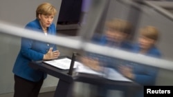 German Chancellor Angela Merkel delivers a government policy statement at the lower house of parliament, the Bundestag, in Berlin, on June 27.