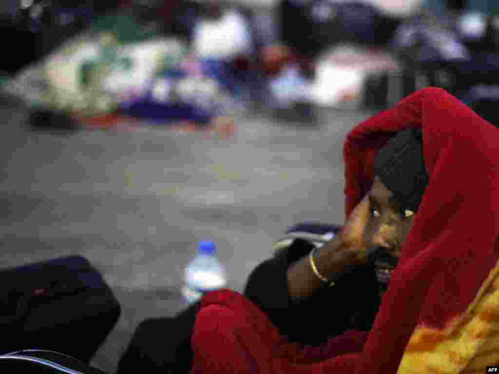 A man who fled Libya waits at the border between Libya and Tunisia in March 2011.