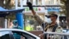 A traffic policeman checks the ID of a driver at a checkpoint amid the coronavirus pandemic in Tashkent. (file photo)