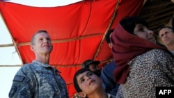 Commander of the NATO-led International Security Assistance Force (ISAF) U.S. General Stanley McChrystal visits a local bazaar in Afghanistan's Logar Province in late August.