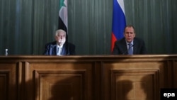 Russian Foreign Minister Sergei Lavrov (right) with his Syrian counterpart, Walid al-Mualem, at a news conference following their talks in Moscow on January 17