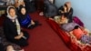 An Afghan family sits in an International Organization for Migration transit center in the western Herat Province after returning from Iran on August 2. 