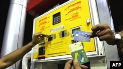 Iranians show their rationing cards at a gas station 