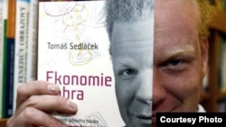 Economist Tomas Sedlacek holds a Czech edition of his book "The Economics of Good and Evil."