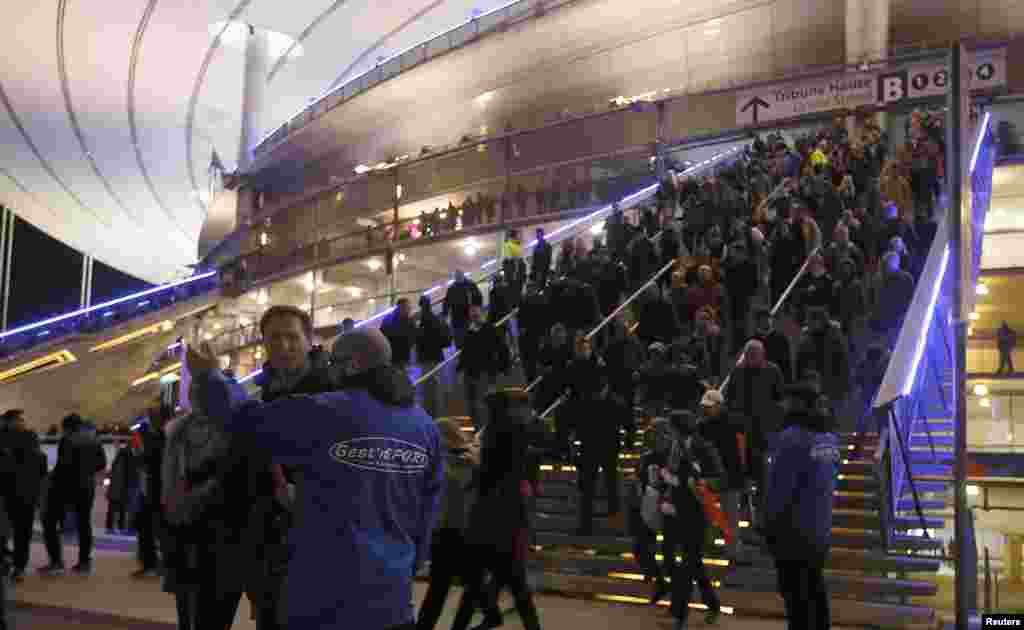 Crowds leave the Stade de France where explosions were reported to have detonated outside the stadium during an international soccer match between France and Germany.