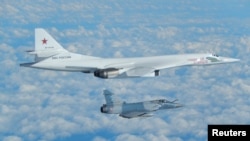 A Russian Blackjack bomber is intercepted and escorted by a French Mirage jet above French coast in this image taken and distributed by the French Air Force in February 2017.