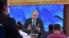 Journalists watch Russian President Vladimir Putin during his annual press conference, via video link from the Novo-Ogaryovo state residence, in Moscow on December 17, 2020.