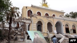 A portrait of Muammar Qaddafi is placed outside the destroyed premises of the General People's Congress after it was targeted by a NATO air strike in Tripoli on June 6.