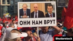 "They Are Lying To Us": A protest against pension reform in Moscow with a placard featuring Russian President Vladimir Putin (left), Anton Siluanov, the first deputy prime minister, and Prime Minister Dmitry Medvedev.