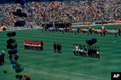 The teams for the Soviet Union (left, in red) and Mexico (right, in green) pause before the kickoff of their group stage match in the 1970 World Cup at Estadio Azteca in Mexico City on May 31, 1970. The match ended in a 0-0 draw.