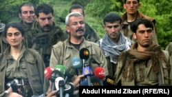 Jigar (one name), commander of the first group of withdrawing PKK fighters arriving in northern Iraq from Turkey, talks to reporters on May 14.