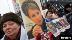 Supporters of jailed opposition leader and former Prime Minister Yulia Tymoshenko hold portraits of her during a rally in front of the appeals court building in Kyiv on February 15.