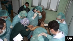 Medics attend to a man at a hospital in Khan Al-Assal in northern Aleppo Province on March 19, amid allegations that chemical weapons were used in fighting between government forces and rebels.