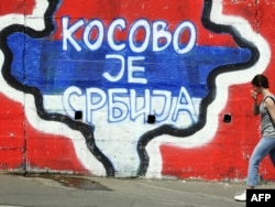 A map of Kosovo painted on a wall with the words "Kosovo is Serbia" in Belgrade.