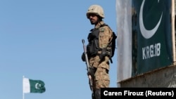 A Pakistani soldier stands guard at an outpost in the town of Angoor Adda near the Afghan border area targeted by the strikes. (file photo)