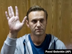 Russian opposition leader Aleksei Navalny -- who is now serving a 30-day jail sentence -- gestures in a courtroom in Moscow on August 27.